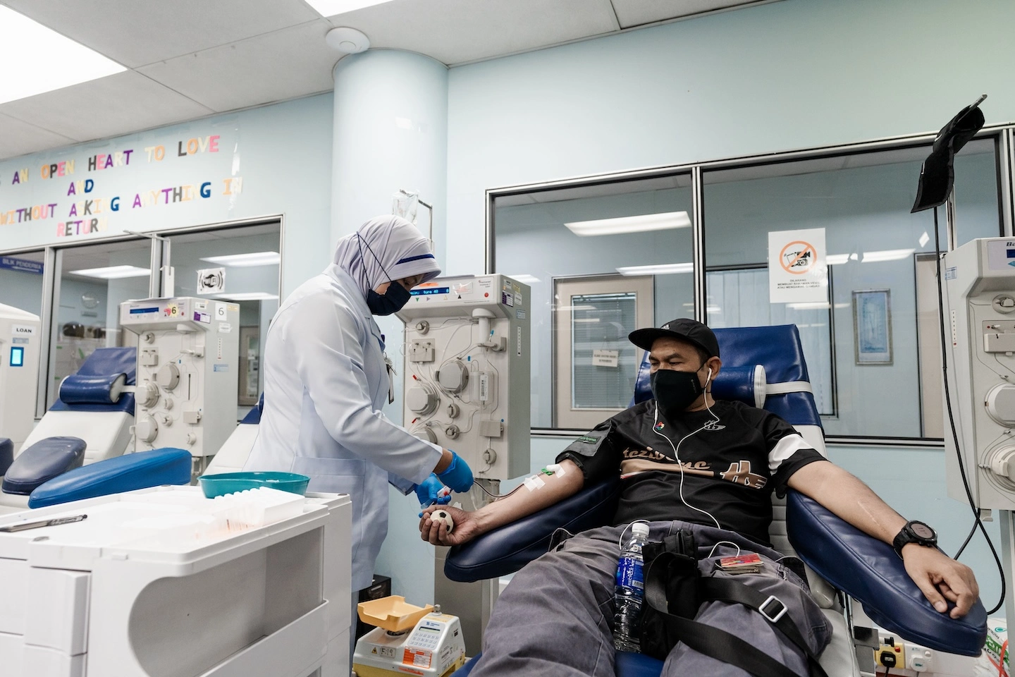 nurse drawing blood from patient