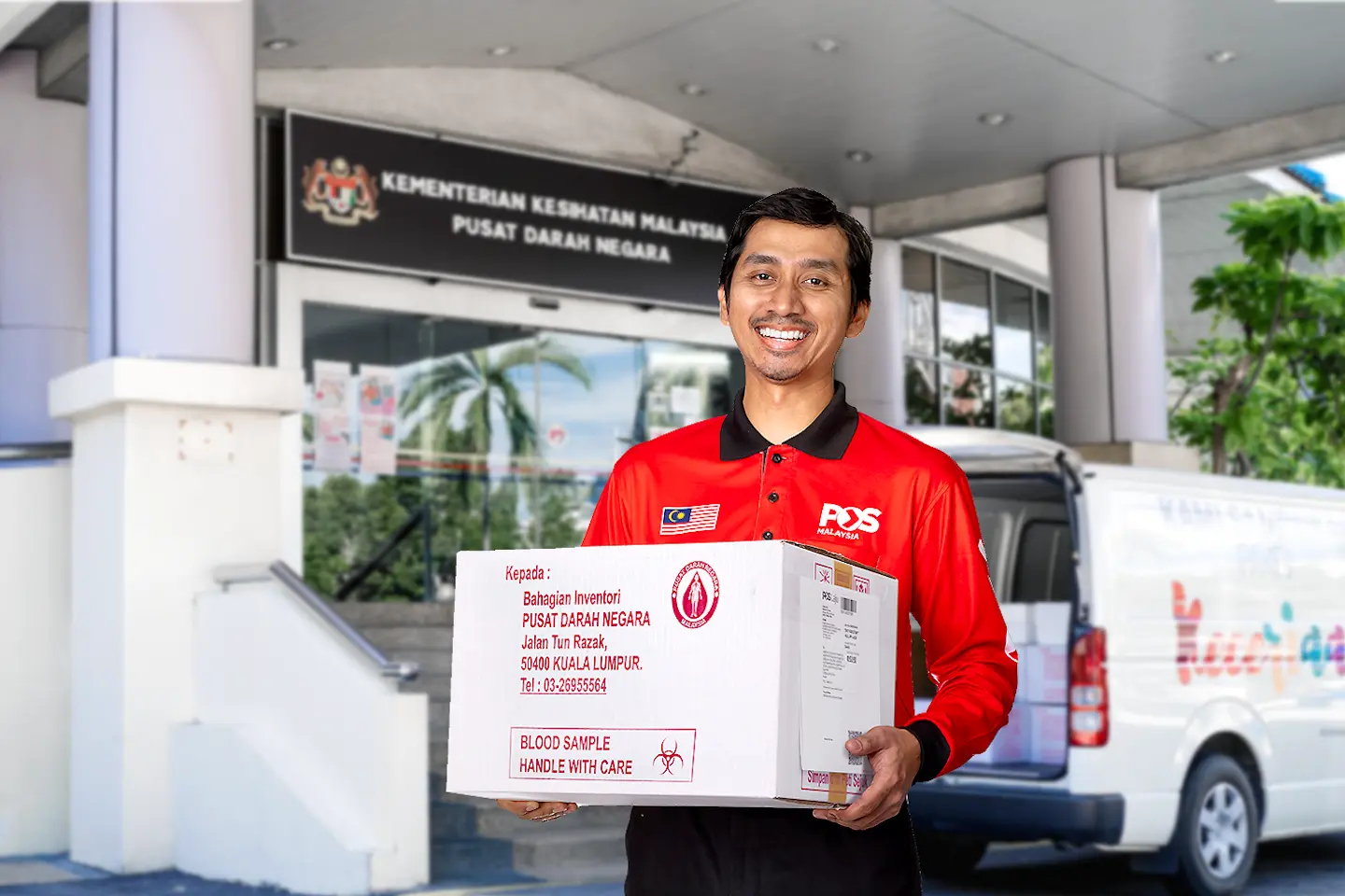 Pos Malaysia staff holding a box containing blood sample.